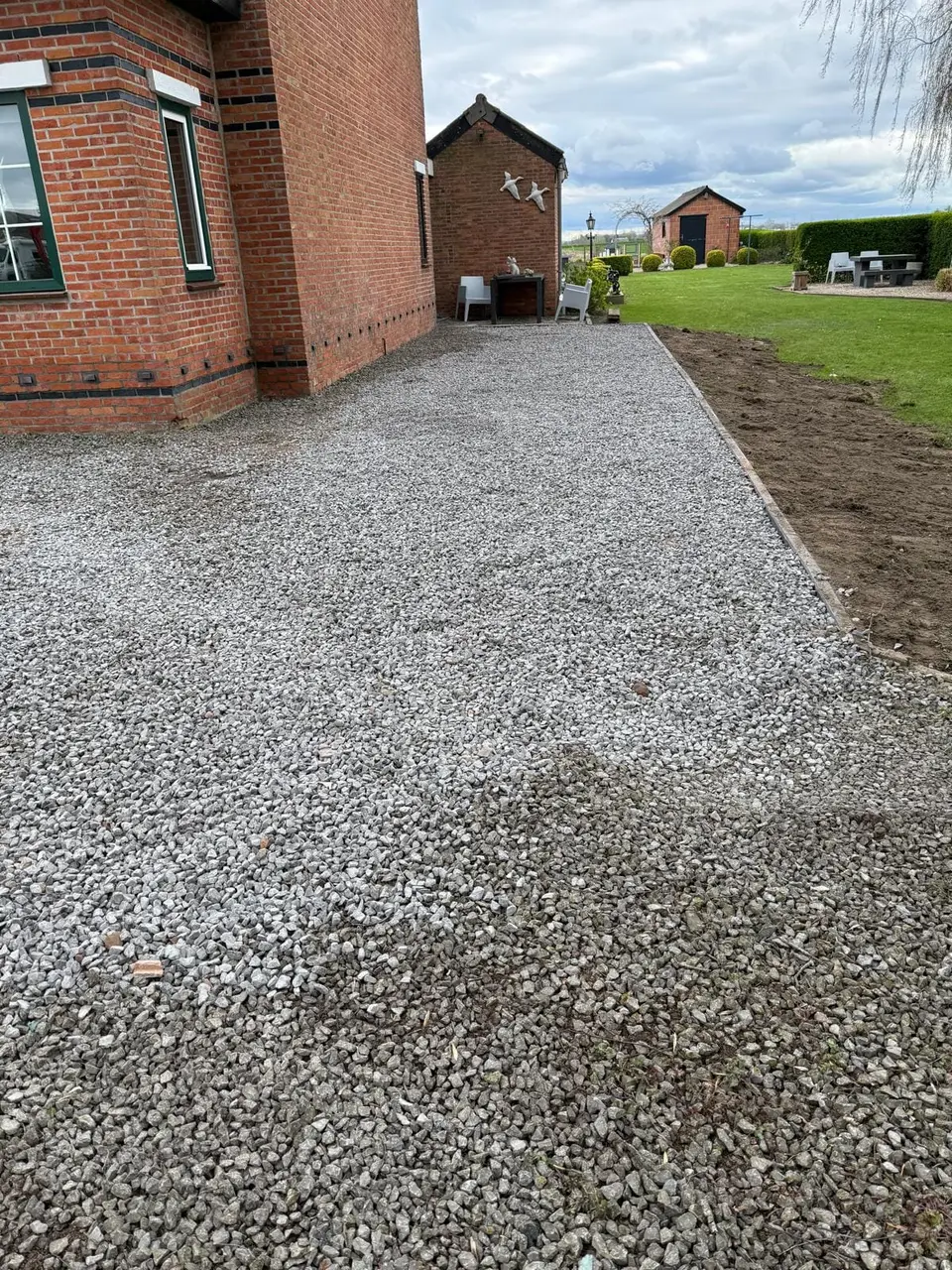 Afgewerkt grindpad langs de woning